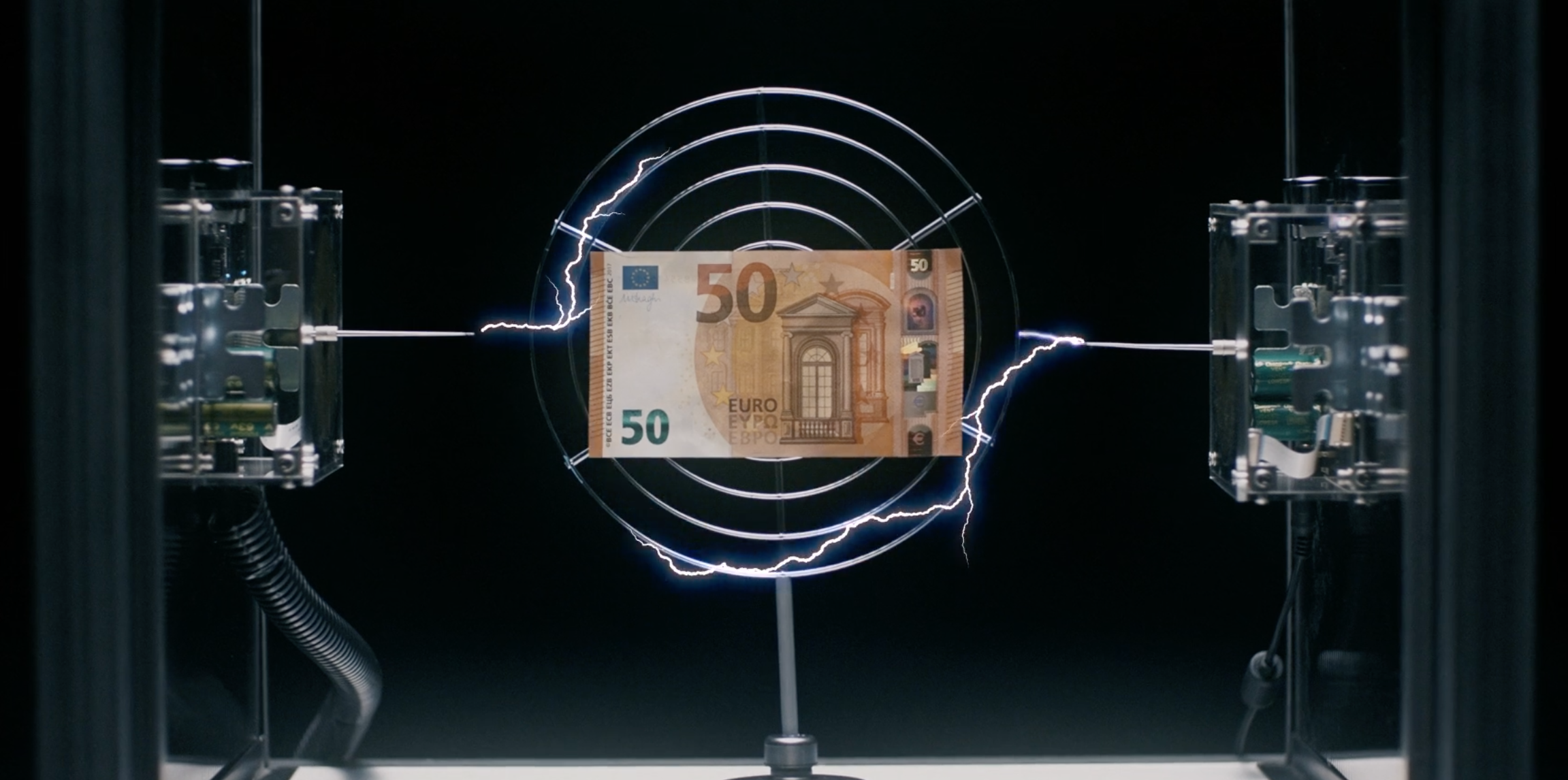 50 Euro banknote inside a coil with electrical sparks, symbolizing monetary value or currency exchange with a black backdrop.