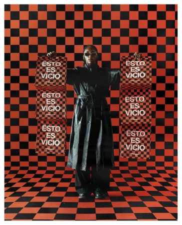 Model in black leather coat wearing sunglasses holding red and black checkered bags against a matching checkered background.
