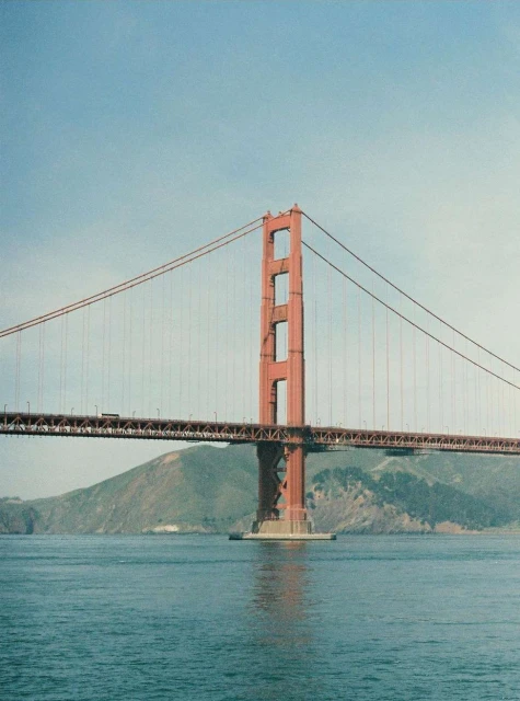 View of the Golden Gate Bridge in San Francisco, California, with blue sky and water on a sunny day, capturing its iconic architecture.
