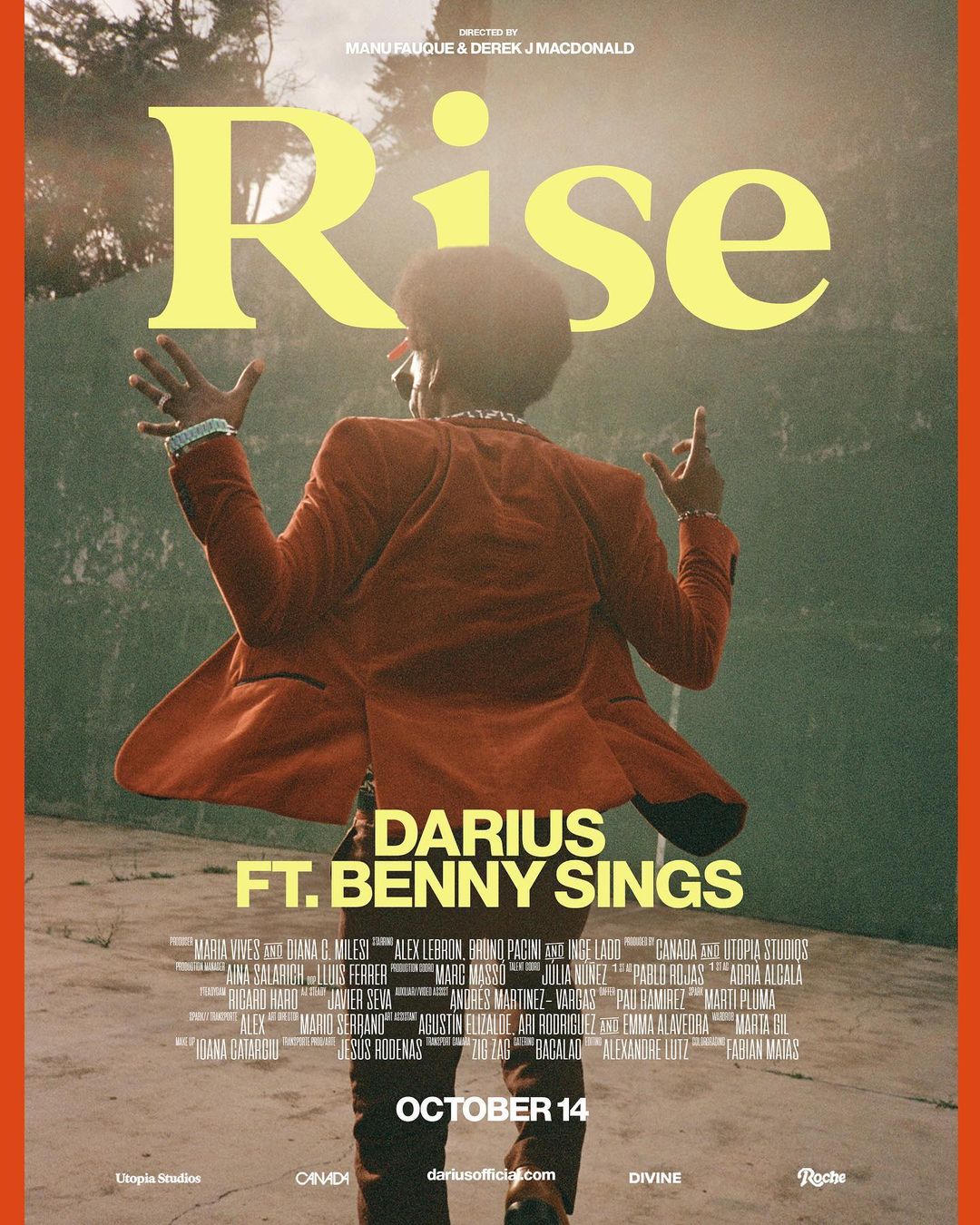 Music album cover art featuring a male singer in an orange suit against a muted green and concrete background with yellow typography.
