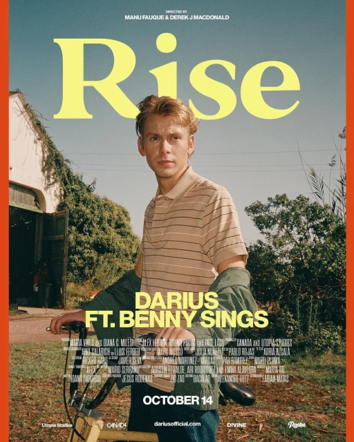A young man with short hair sits on a yellow bicycle on a music album cover with a house and greenery in the background.