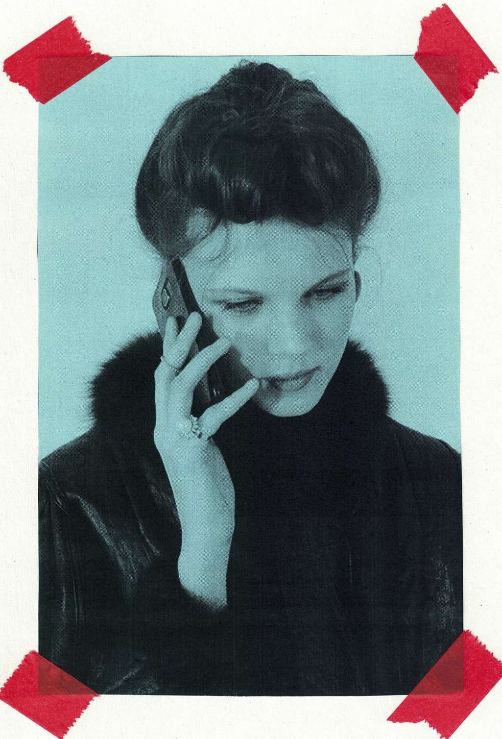 A young woman in a fur-collared coat holds a smartphone to her ear in a close-up shot, taped to a blue background.