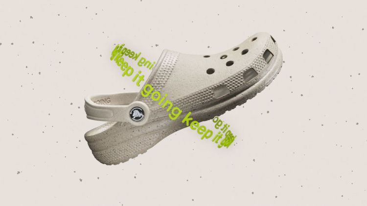 Beige Croc sandal floating against a speckled background with green text accents, showcasing casual footwear.