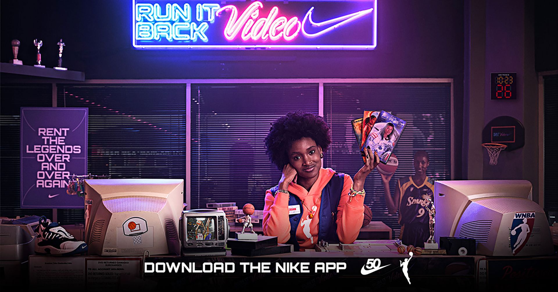 A young woman surrounded by basketball memorabilia promoting Nike's 'Run it Back Video' campaign in a vintage office setting.