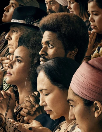 Diverse group of people looking upward. The group is made up of men and women of various ages, complexions, and cultural backgrounds.