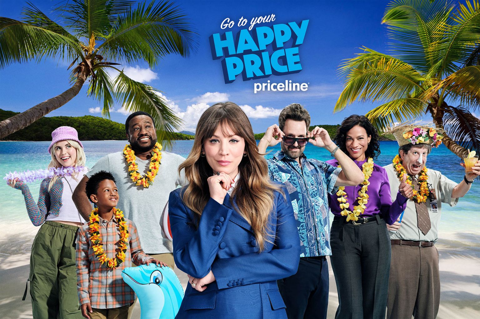 Group of adults and a child on a beach, wearing leis, with one woman in a blue suit in the foreground.