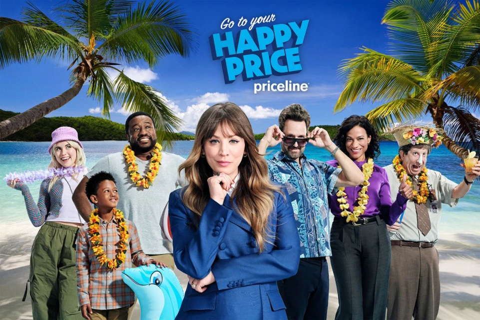 Group of adults and a child on a beach, wearing leis, with one woman in a blue suit in the foreground.