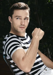 Portrait of Nicholas Hoult in a black and white striped t-shirt photographed by Emily Shur in Los Angeles.
