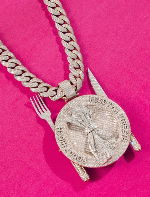 Diamond chain and pendant featuring a fork, knife, and wheat design on a pink background. Jewellery design for luxury style visuals.