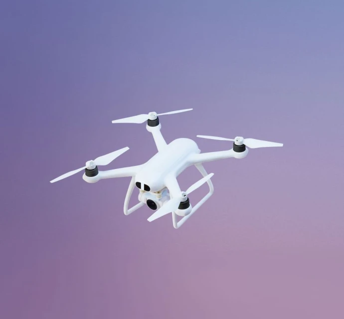 Drone against a purple-pink gradient backdrop. The drone is white with four propellers and a camera visible at the front.