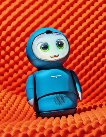 A blue toy robot with a screen for a face is set against a red, textured, geometric background. The robot has large, green eyes.