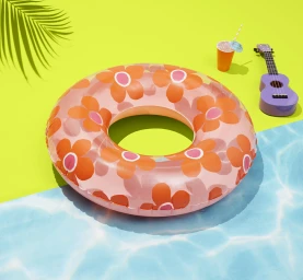 Pink and orange floral print inflatable inner tube pool float on a bright yellow and blue surface with a ukulele and drink