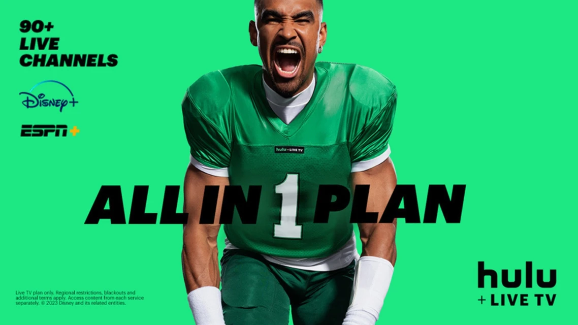 Football player in uniform shouts with Hulu + Live TV advertisement featuring Disney+ and ESPN against a green background.