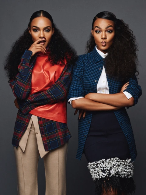 Two beautiful women pose in studio wearing fashionable outfits with bold patterns and textures, showcasing modern style and elegance.