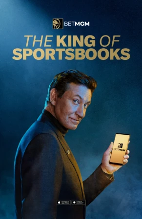 Man in suit holding smartphone with BetMGM app on a blue background with BetMGM logo and the text 'The King of Sportsbooks'.