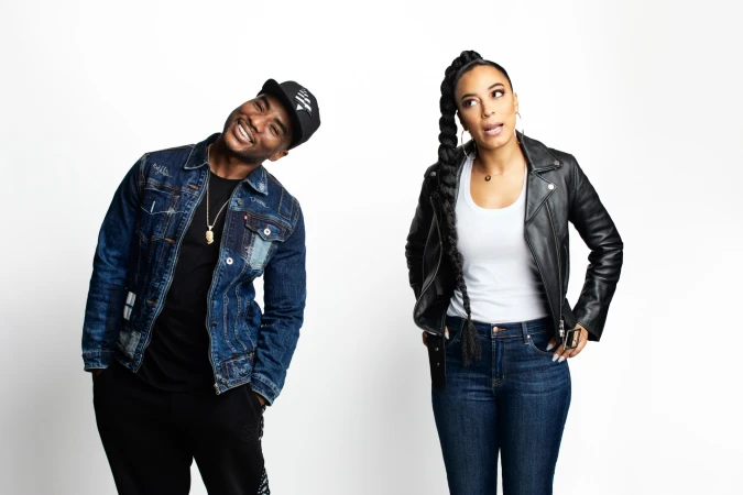 Portrait of a Black man in a denim jacket and cap next to a Black woman in a leather jacket against a white background.