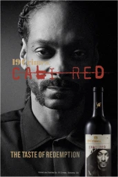 Portrait of Snoop Dogg with a 19 Crimes Cali Red wine bottle, photographed by Erik Umphery.