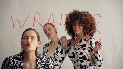 Three women in patterned tops pose in front of a white background with hand-drawn text and a heart. Red lipstick and jewelry are visible.