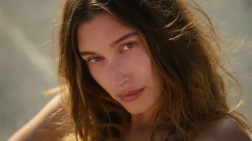 Close-up portrait of a woman with long brown hair blowing in the wind, shot by cinematographer Jon Gourlay.