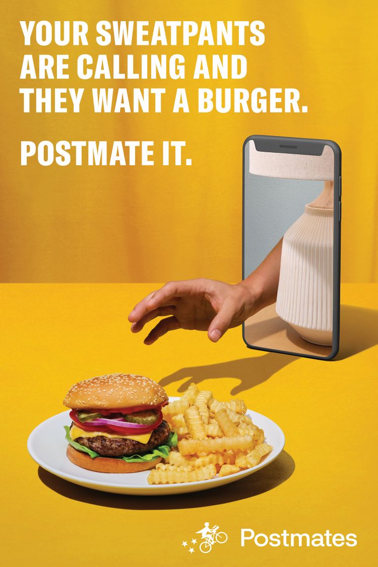 Burger and fries on a plate, with a hand reaching out from a smartphone on a yellow background, advertising Postmates delivery.