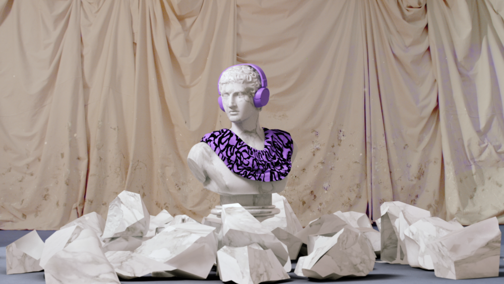 Bust sculpture with purple headphones and patterned collar, staged against draped fabric and faux stone fragments in a studio setting.