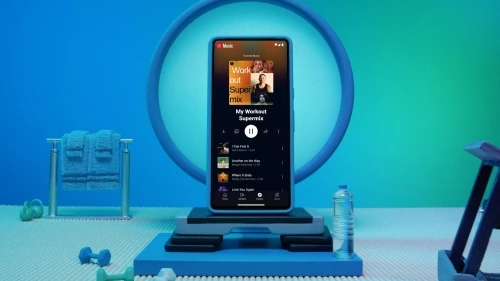 Smartphone displays YouTube Music with workout playlist surrounded by gym props, dumbbells, water bottle, and step platform on blue background.