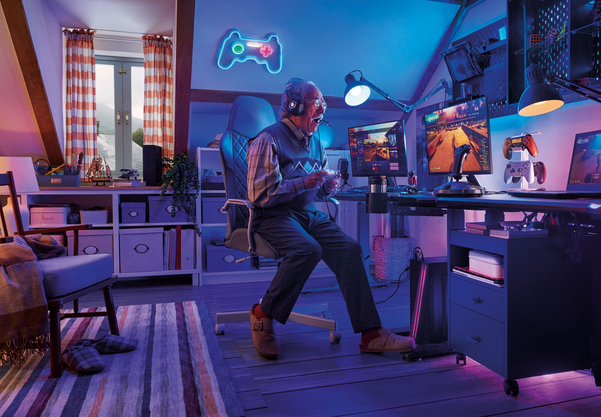 Excited elderly man wearing a headset playing a video game with a controller, sitting in a gaming chair in an attic game room.