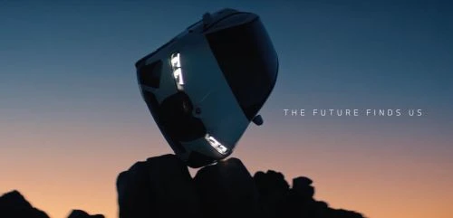 Futuristic car hovers above rock formation against a gradient sky at dusk, showcasing automotive innovation and design.