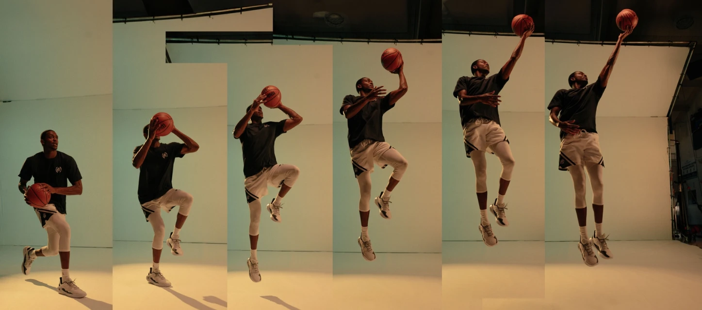 African American man in dynamic basketball sequence, mid-air jump shot, athletic apparel, studio lighting, sports action theme, and energetic mood.
