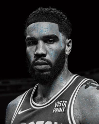 Close-up portrait of Jayson Tatum in a sports jersey with blue water droplets on his face