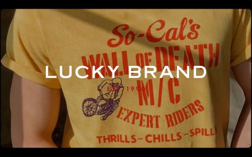 Yellow Lucky Brand t-shirt featuring a motorcycle rider graphic. The words 'So-Cal's Wall of Death' and 'Expert Riders' printed on the tee.