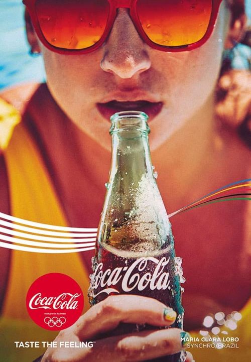 Close-up of a woman drinking Coca-Cola from a bottle, wearing sunglasses. The image is stylized as an advertisement.