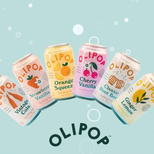 Assorted Olipop cans featuring vintage cola, strawberry vanilla, orange squeeze, cherry vanilla, classic root beer, and ginger lemon.