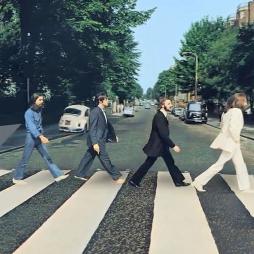 Four men in suits crossing Abbey Road on a zebra crossing, vintage photo of The Beatles album cover, London street, daytime.
