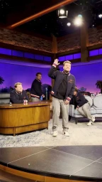 James Corden waving on a television studio set with multiple versions of himself visible around the stage by Peter Quinn.