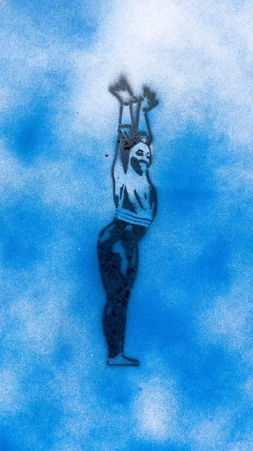 Silhouette of an athletic male figure with raised arms, rendered in blue and white spray paint on a matching blue background.