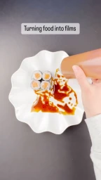 Hand pouring dark soy sauce from a bottle onto a white plate with sushi rolls, forming a portrait silhouette.