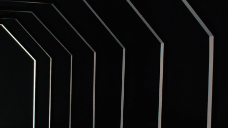 A dark geometric tunnel with glowing white linear edges receding into the background.