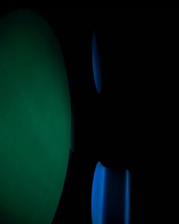 Abstract neon green and blue lights glowing softly against a dark, low-key background.