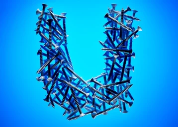 Letter U formed by a dense pile of metallic wood screws against a vibrant blue gradient background