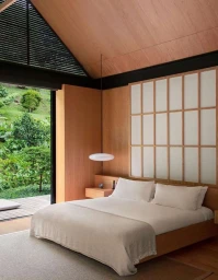 Modern minimalist bedroom interior featuring a low wooden platform bed with white linens and a shoji screen headboard.