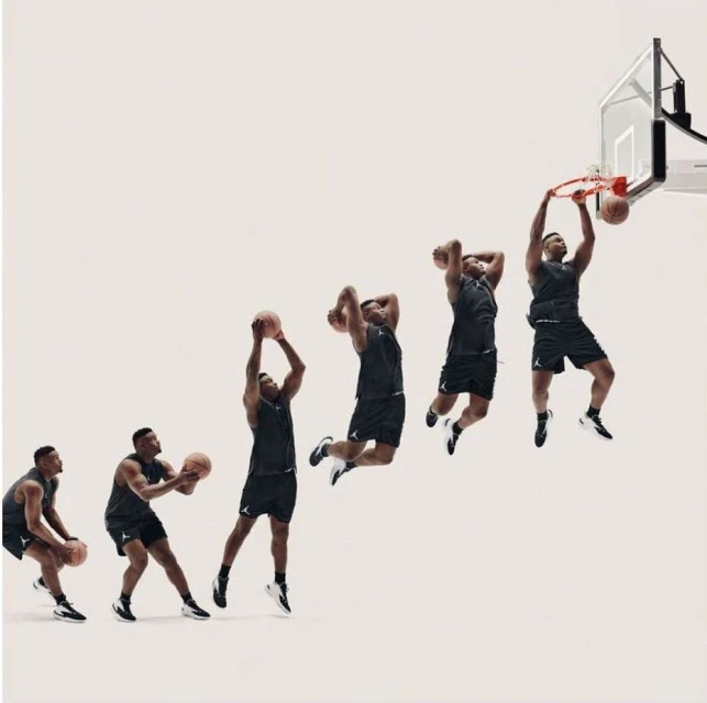 Sequence shot of an adult male basketball player in sportswear performing a slam dunk against a bright neutral studio background.