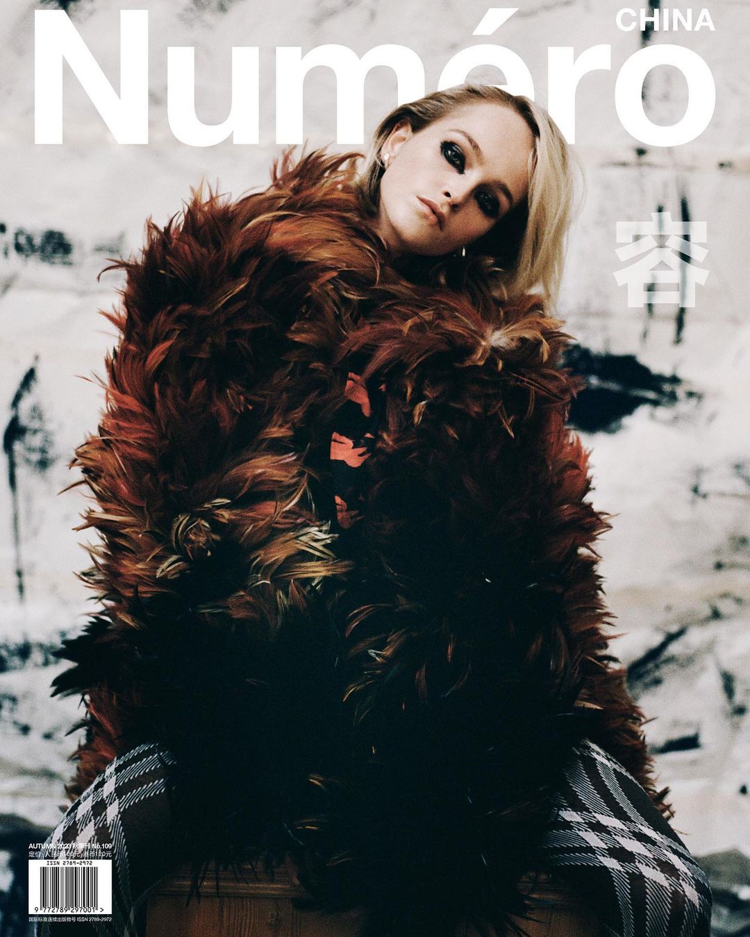 Magazine cover featuring a blonde woman in a feathery coat, with "Numéro China" in white text at the top and a textured background.