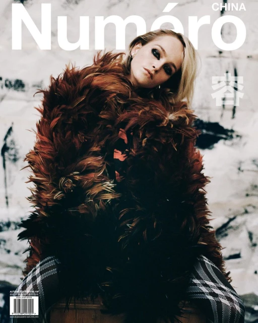Magazine cover featuring a blonde woman in a feathery coat, with "Numéro China" in white text at the top and a textured background.