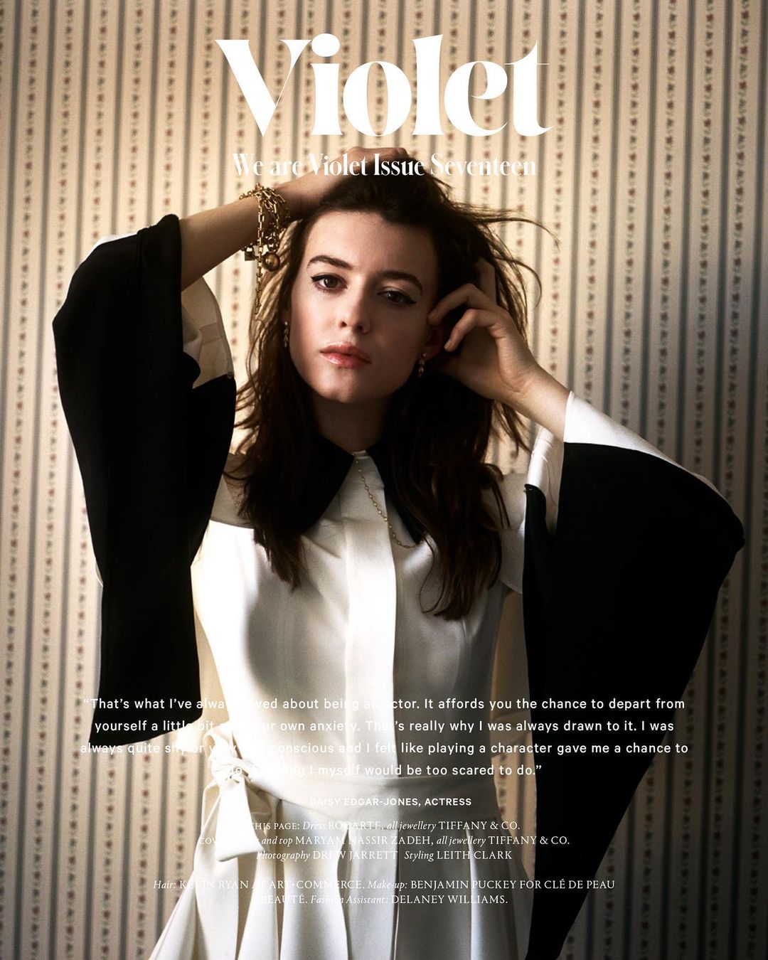 Magazine cover featuring a woman in a black and white dress against a patterned backdrop, showcasing a modern and stylish editorial aesthetic.