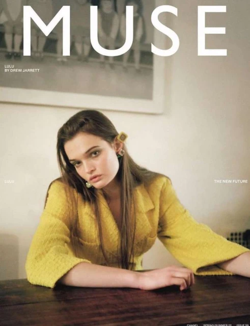 Magazine cover featuring a woman in a yellow blazer sitting at a dark wooden table, with the word 'MUSE' in large white letters.