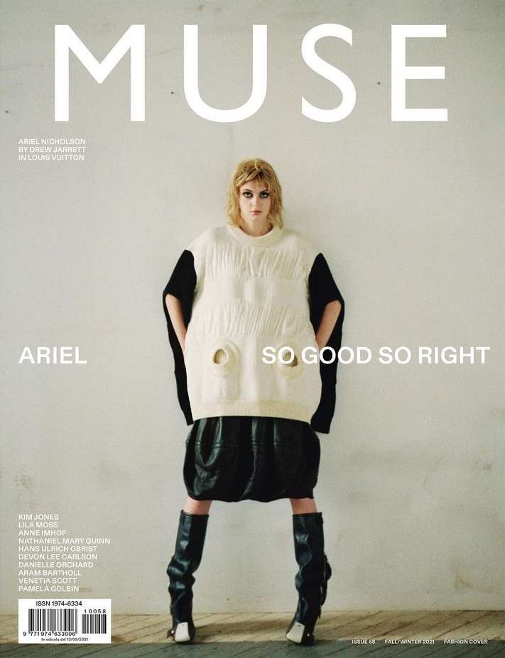 Fashion magazine cover featuring a model in oversized knitwear, leather skirt and boots against a light grey backdrop.