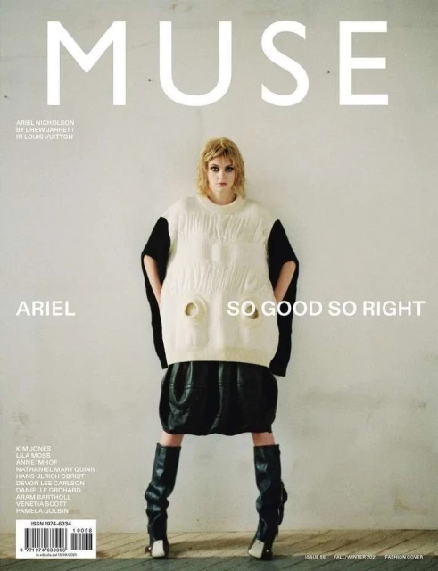 Fashion magazine cover featuring a model in oversized knitwear, leather skirt and boots against a light grey backdrop.