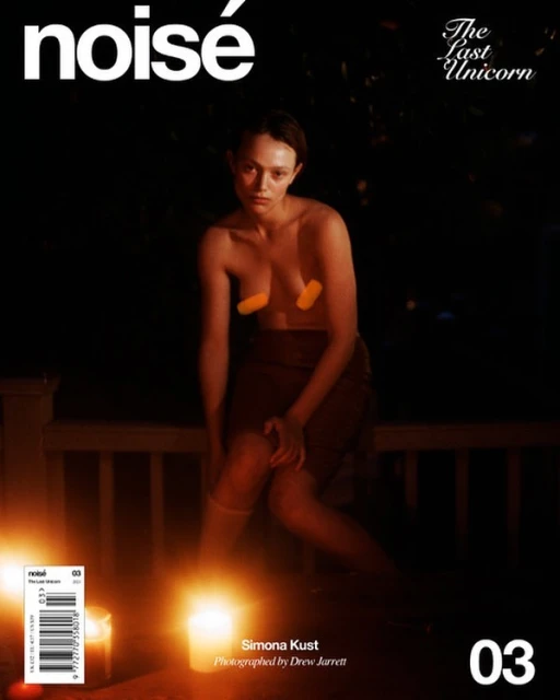 Magazine cover featuring a woman with a dark skirt, posed with candles. The cover also displays the name 'Noise' and 'The Last Unicorn'.