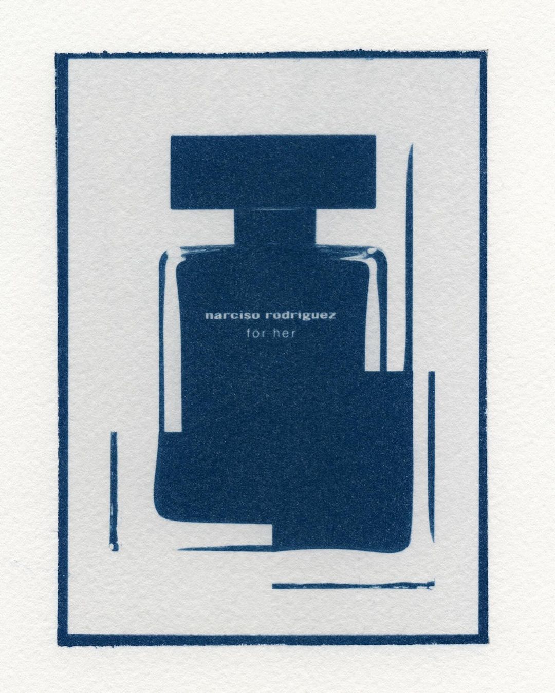 Dark blue cyanotype of a Narciso Rodriguez perfume bottle on textured paper, minimal decor, for fashion or beauty projects.